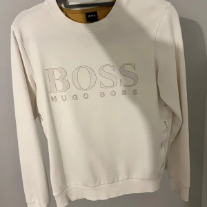 Exklusiv vit-guld Hugo boss tröja - Storlek XS, normal i storleken. Mycket bra skick! Ordinariepris 1700 kr. 