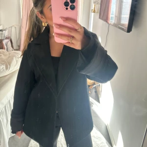 Kortare svart kappa  - Använd fåtal gånger, perfekt till hösten sitter jättefint på. Lite lång o stor på mig är 150 för referens🫰storlek XS då den är oversize kan storleken säkert gå upp till M. pris kan diskuteras❤️