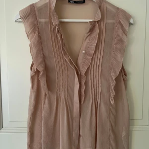 Blus med knappar - Smutsrosa blus med knappar. Använd en gång. 