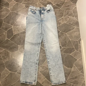 Ljusblå jeans från Vero Moda - Snygga ljusblå jeans från Vero Moda i klassisk denimstil. De har en rak passform och är högmidjade, vilket ger en bekväm och trendig look. Perfekta för en avslappnad stil.