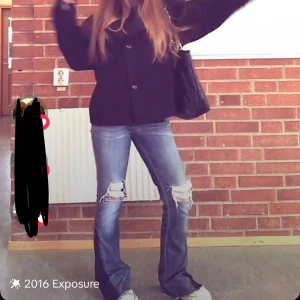 Lågmidjade jeans - Säljer ett par blå jeans med coola slitningar på knäna. De är lågmidjade bootcut/straight leg. Jättesnygga vintage. Midjemåttet rakt över är 35cm och innerbenslängden är 78 ❤️ (obs har några skador vid byxbenet) 