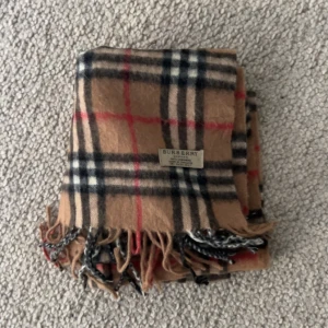 Äkta burbery halsduk - Snygg och klassisk rutig halsduk från burbery. Håller dig sjukt varm och passar till nästan allt, helt ny i perfekt skick. 