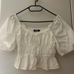 Vit blus   - Säljer en söt vit blus med puffiga ärmar och en volangkant nedtill. Använd två gånger så den är som i nytt skick. 💓