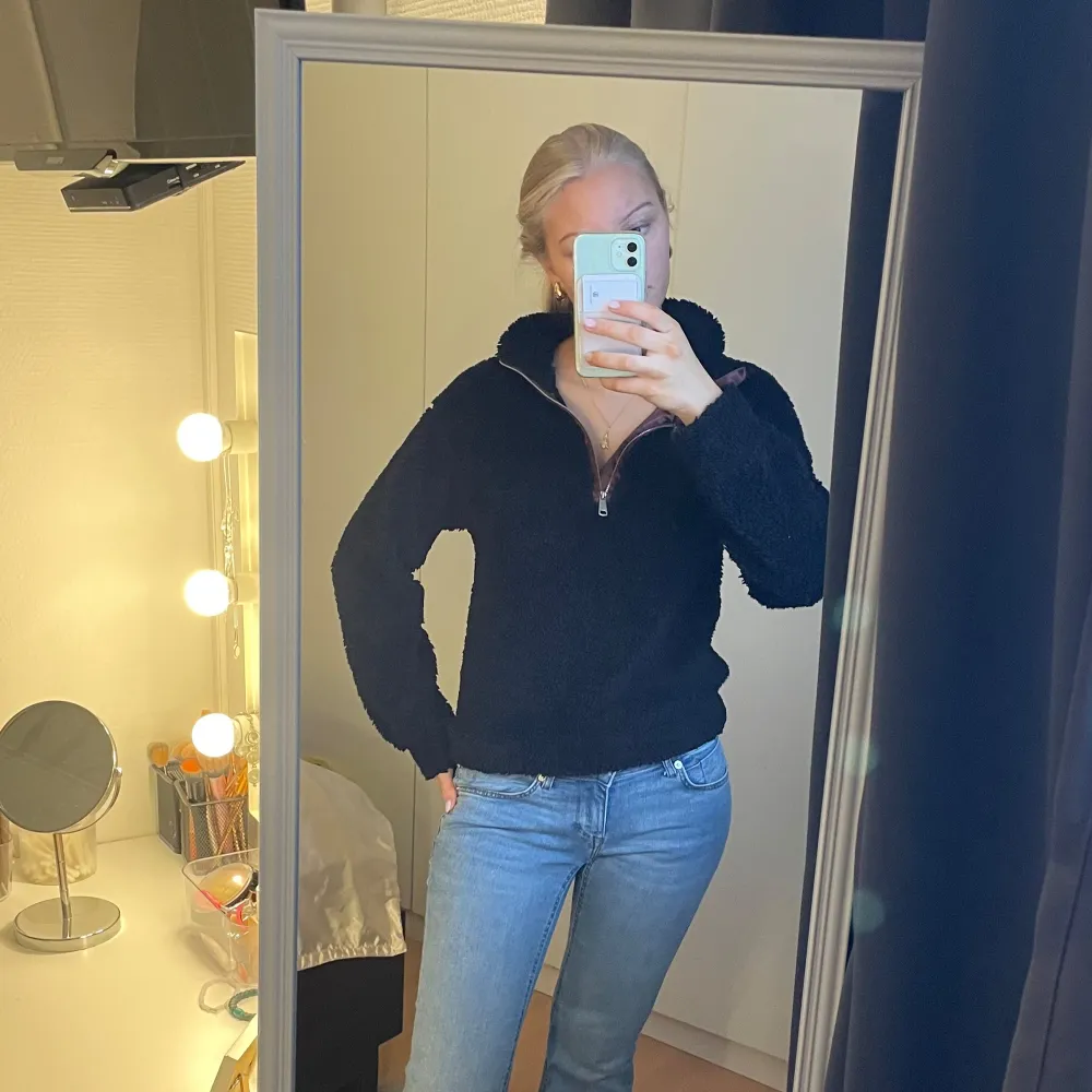 Mysig svart fleece hoodie med halv dragkedja. Perfekt för kyliga dagar med sin mjuka och varma känsla. Den har en hög krage och långa ärmar, vilket gör den idealisk för både inomhus och utomhusbruk. Passar mig som vanligtvis bär storlek S.. Neuletakit & Villapaidat.