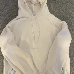 Vit hoodie med tryck - Säljer en vit hoodie med ett coolt tryck på baksidan som visar en stadssilhuett och texten 'HAVE FUN BEAUTIFUL'. Hoodien har en klassisk design med dragsko i huvan och långa ärmar. Perfekt för en avslappnad stil.