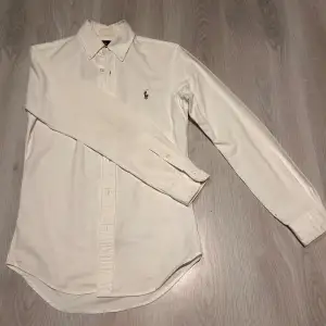 Ralph Lauren skjorta Vit, Storlek S men passar någon med storlek M. Säljer för 559kr vid snabb affär, pris kan diskuteras!