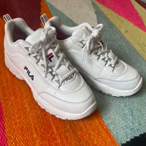 Fila Strada White Leather Sneakers - White chunky sneakers Strada from FILA made in White leather. Retro sneaker style.  Worn once, very good condition. some wear on the soles that can be cleaned.  -Tagged Size 39, fees true to size
