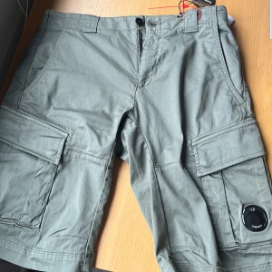 Gröna cargoshorts från C.P. Company - Säljer ett par gröna cargoshorts från C.P. Company.  Köpta för 2500kr, lappar och allt finns kvar därav priset 