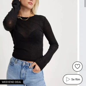 Svart långärmad topp från Nelly  - Snygg svart långärmad topp från Nelly som i ett transparent material. Perfekt för lager-på-lager eller en kväll ute. Toppen har en enkel design med rund hals och är i mycket bra skick.