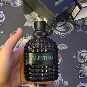 Valentino Uomo Born in Roma Green Stravaganza - Säljer en flaska Valentino Uomo Born in Roma Green Stravaganza. Flaskan är svart med ett unikt nitat mönster och har en elegant svart kork. Parfymen kommer i en stilren förpackning med gröna detaljer. Perfekt för den som vill ha en doft med karaktär och stil. Låken är sänder men de funkar som vanlingt 