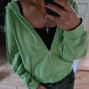 Hoodie med dragkedja  - "Färgstark grön hoodie i gott skick, knappt använd. Inköpt på H&M för ett tag sedan."