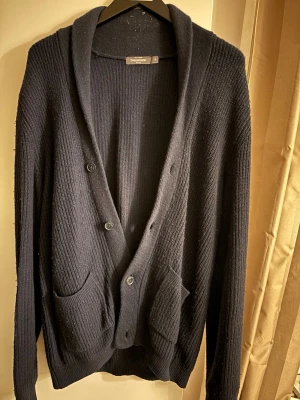 Stickad cardigan  - Mysig mörkblå cardigan. Perfekt att slänga över en t-shirt eller skjorta för extra lager.