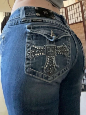 Miss Me blå jeans med gems - Säljer ett par blå bootcut Miss Me jeans med snygga detaljer och gems på bakfickan. Super snygga och I toppen skick. Jag är 168cm lång. Midjemått:42cm innerbenslängd: 85cm