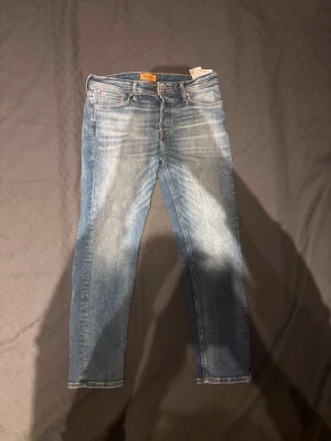 Jack & Jones jeans  - Tja, säljer ett par snygga jeans ifrån Jack & Jones. Inprincip nytt skick. Har används få tal gånger. Snygg tvätt på jeans. Priset kan diskuteras. Fraktar 1-3 dagar. Skriv om du vill ha mått på jeans så löser ja de!