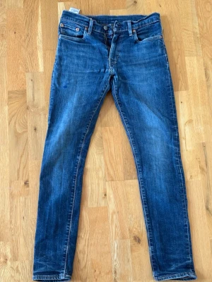 Mörkblå skinny jeans med fem fickor - Snygga mörkblå skinny jeans med klassisk femficksdesign och dragkedjegylf. Jeansen har en lätt tvättad look och raka benslut. Passar perfekt till en avslappnad stil och är tillverkade i ett stretchigt denimtyg för extra komfort. Blått märke på låret