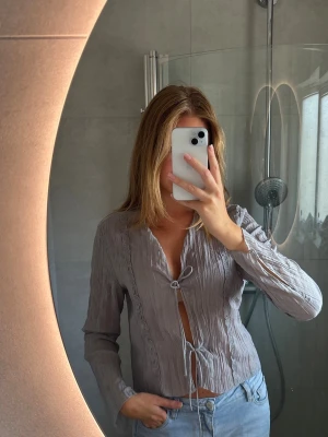 Ljusblå/grå blus med knytning - Ljusblå/grå blus med knytning fram💗💗 Storlek M men liten i storleken☺️