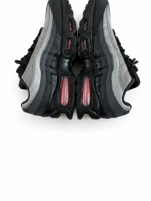 Svarta och grå Air Max sneakers - Snygga sneakers i svart och grått med meshpaneler och tydliga Air Max-detaljer i sulan. Skorna har svarta snören, reflekterande detaljer och en röd logga på plösen. Perfekta för dig som gillar streetwear och sportig stil.