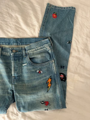 Gucci jeans - Säljer min brors blå jeans med raka ben och flera broderade motiv ifrån gucci. Jeansen har klassisk femficksmodell. Nypris: 8000kr. Skriv för exakta mått. 