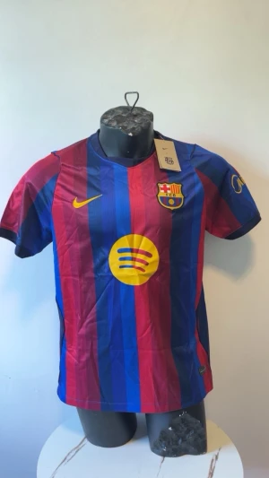 Barcelona matchtröja blå/röd Nike - Snygg Barcelona matchtröja i blått och rött med gula detaljer. Tröjan har klubbmärke, Nike-logga och Spotify-logga på bröstet. Tillverkad i lätt och ventilerande material, perfekt för fotboll eller träning. Klassisk rund hals och korta ärmar.