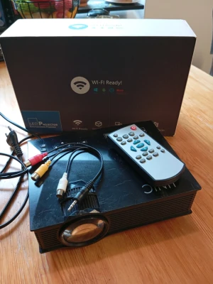 LED Projektor mini wifi android - Säljer en svart UNIC LED-projektor med Wi-Fi Ready-funktion. Medföljer fjärrkontroll, strömkabel och AV-kablar. Perfekt för filmkvällar eller gaming på stor skärm. Kompakt design och enkel att använda.