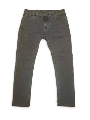 Nudie jeans - Nudie jeans i storlek 29. Riktigt schyssta mörkgråa jeans som passar till allt. Passform slim. 