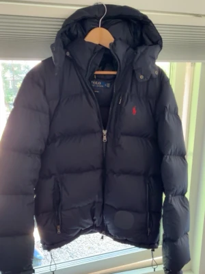 Ralph lauren puffer - Navy ralph lauren puffer storlek M, bra skick men har en defekt som täckts upp  därav det låga priset