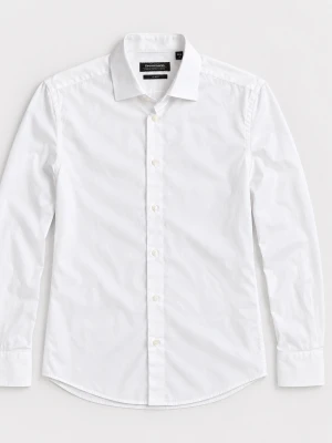 Vit Dressman Skjorta  - Snygg vit skjorta med lång ärm och klassisk krage. Skjortan har knäppning framtill och är tillverkad i ett slätt bomullstyg. Perfekt för en clean och stilren look.