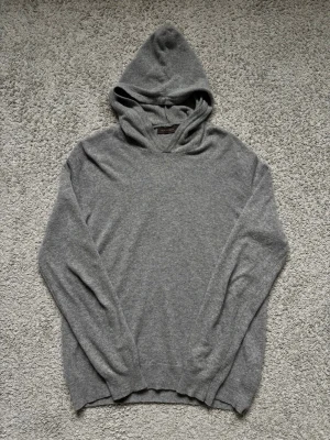 Grå hoodie från Oscar Jacobson - Grå Oscar Jacobson hoodie i storlek M. Moddelen på bilden är 178 och tröjan är i mycket bra skick. Kom privat vid minsta lilla och pris går givetvis att diskutera🍾