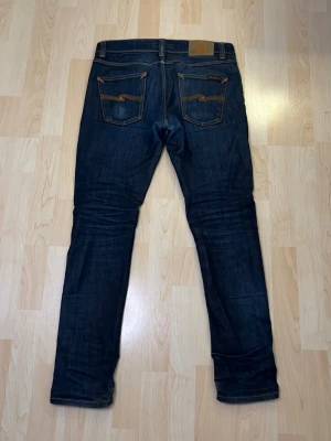Mörkblå jeans från Nudie Jeans - Säljer ett par mörkblå jeans från Nudie Jeans i storlek 29:32