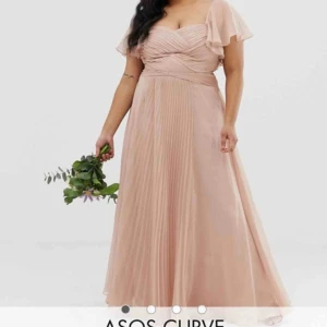 Balklänning  - Super fin ljusrosa balklänning inköpt 2019 från asos för ca 1000kr. Endast använd vid ett tillfälle. Den har isydd resår i båda ärmarna men det går att ta ut.