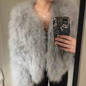  - Ljusgrå fjäderjacka från CPH Feather. Storlek M/L men passar perfekt på mig som vanligtvis har storlek S. Går att knäppa ihop med 4 hakar. Skön och snygg jacka, använd 3-4 gånger så den är i väldigt bra skick.   Köparen står för frakt 