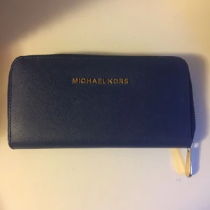  - Mörkblå plånbok från Michael Kors. Den är i nyskick