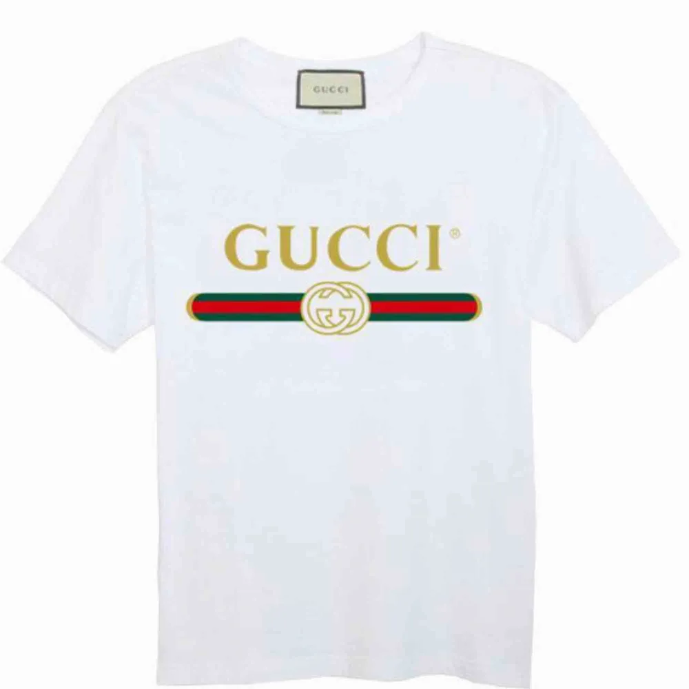 Gucci T-Shirt  Fabric: 100 Percent Cotton   Color: White   Sleeve: Half Sleeve   Pattern: Printed   . Neck Shape: Round   . Fit: Regular Fit. T-shirts.