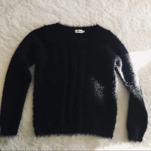 Fluffig svart tröja S/M Agnes collection - En superfin och mysig fluffig, mjuk tröja i st S men passar även en M. I nyskick! Mått: armhåla-armhåla: 50 cm, längd ovanifrån och ned: 57 cm.