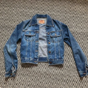 Jeansjacka GUL&BLÅ, str S. - Säljer en jeansjacka från märket GUL&BLÅ. Storleken är S och jackan har en rätt så kort passform. Fin kvalité trots begagnat skick. Säljer för att den inte längre kommer till användning.                                            Pris 200 kr. Köparen står för frakt 65 kr.