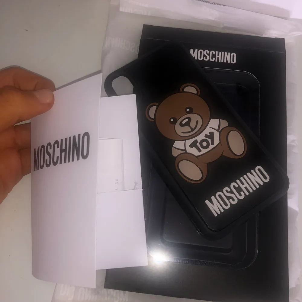 Ett fint skal från Moschino store London i nyskick! Köptes sommaren 2020 i butik, med i priset ingår även köpkvitto, påse, äkthetsbevis, inslagning och original kartong.  . Accessoarer.
