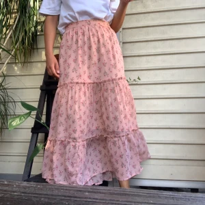Perfekta sommarkjolen - Superfin somrig kjol i ett luftigt, följsamt material.  Rosa med blommönster. Har insydd underkjol. Varsamt använd. Small, men passar även medium. Köparen står för frakt, kan mötas upp i centrala Stockholm 🌸