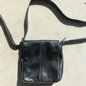 Väska  - Jättesnygg och praktisk väska i svart skin med bruna sömmar