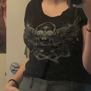 T-shirt från H&M - Det är en t-shirt från divided från h&m och den är svart med ett dödskallemärke. Det är storlek 38.