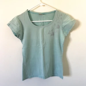  - Garderobsrensning🌸 en basic ljusblå tshirt men segelbåtar vid vänster axel ~ frakt ca10kr