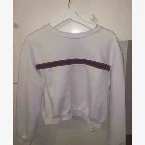  - En vit tjocktröja (magtröja) med röd & blå rand på bröstet från h&m i fint skick! 