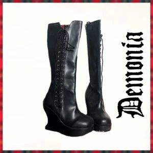 Demonia Bravo-100 - Demonia kilklackar med annorlunda klack! Använda 1-2 gånger för fotografering. Klackhöjd; 12,5 🌹Nypris 1350kr 