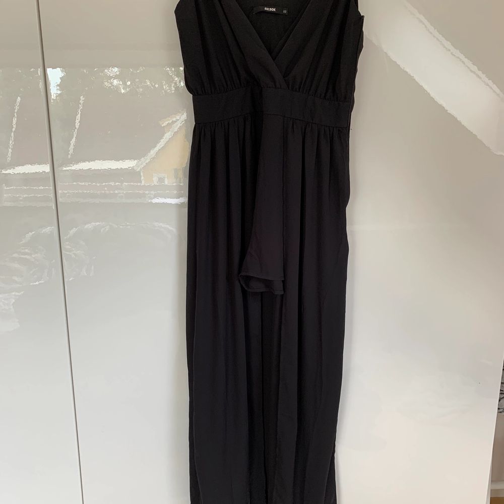 En svart kort jumpsuit men lång klänning | Plick