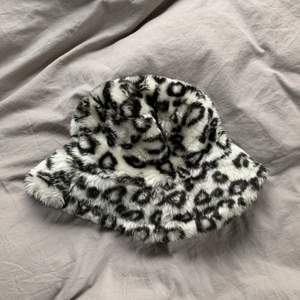 Fluffig bucket hat med svart vit leopard mönster. Köpt secondhand för två år sen och är i bra skick, har bara insett att jag inte använt den på sistone så väljer att sälja istället. Storlek 54 