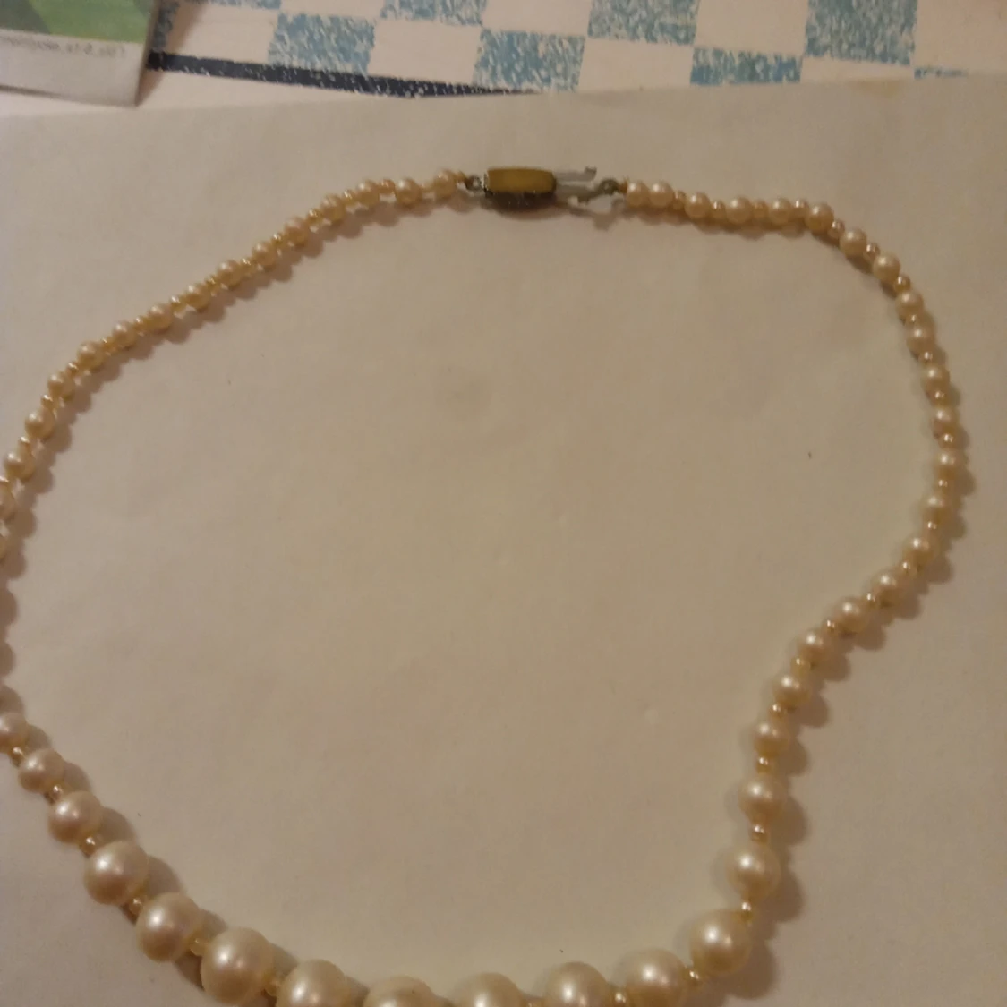 Pärlcollier med vita pärlor och lås med vit sten . - 90