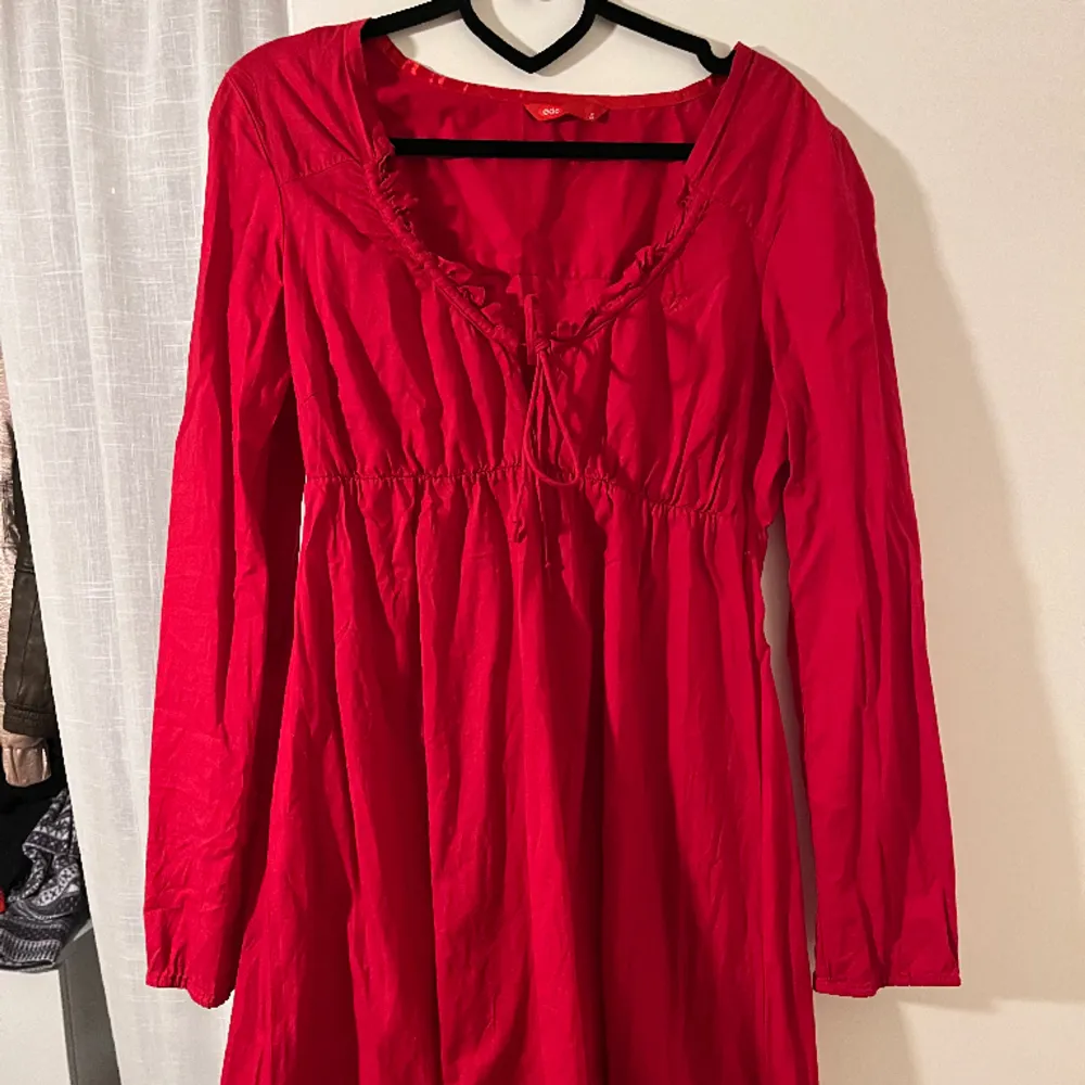  Fin röd klänning med snören och långärmad. Klänningar.