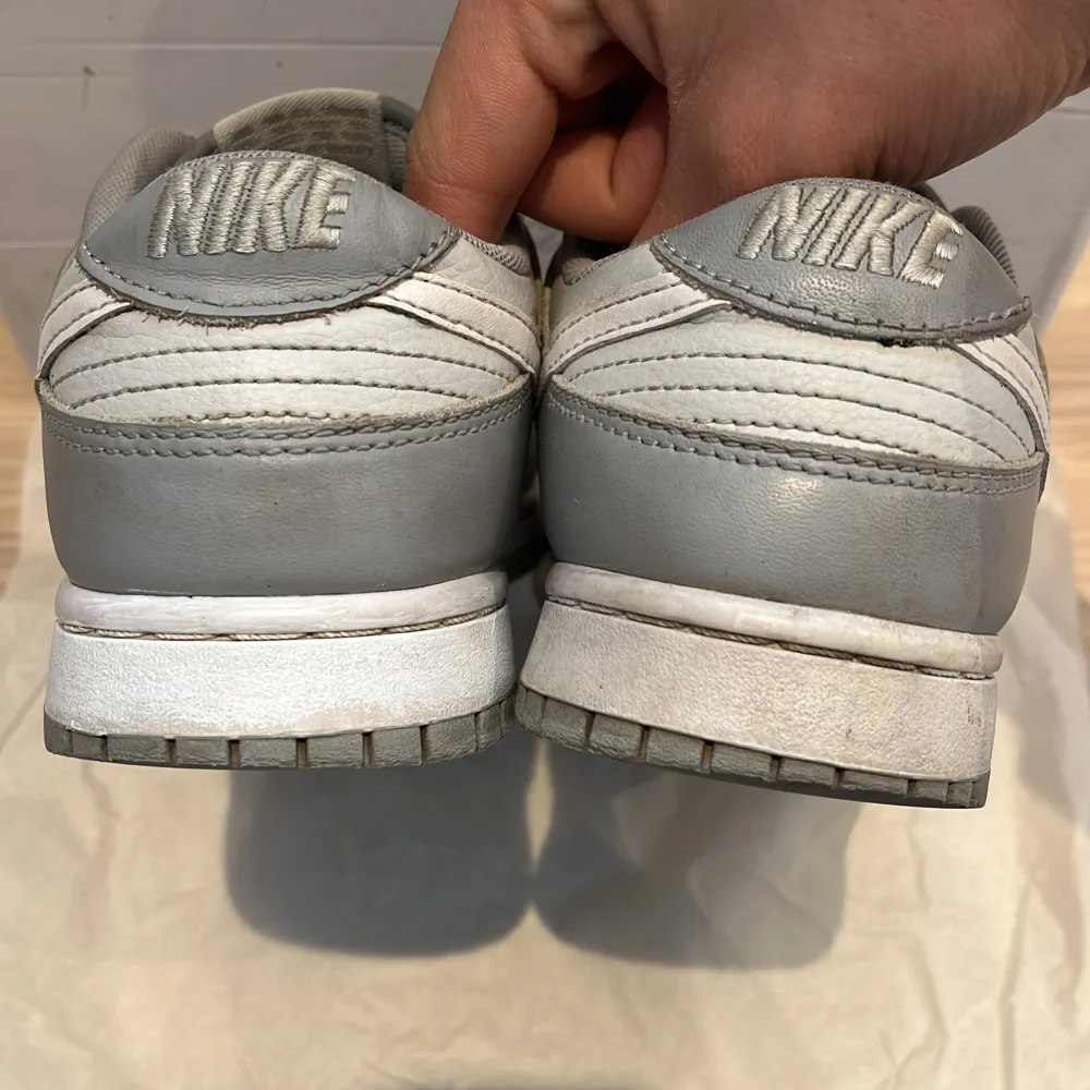 Hej! Säljer ett par sjukt snygga skor från märket Nike, modell Dunk! Lite smått repaintade på midsulan, knappt creasade alls! Super bra skick 👊tvättar självklart innan ja skickar 👍färg: grå och vit, nypris ca 2-3000kr,fel box men den följer ändå med🟡. Skor.