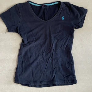 Babytee Ralph Lauren - Supersöt tight t-shirt från Ralph Lauren. Köpt secondhand. Marinblå med ljusare klarblå märke. Sitter smickrande på kroppen,  bra skick!! Stl S. True to size :)