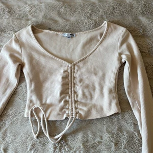 Knyttröja - Jättefin tröja i Xs från Fashion nova. Superfint skick då den inte kommit till användning. Som ni ser går tröjans längd att justera med snörena. Superfin! Skriv om ni har frågor💞