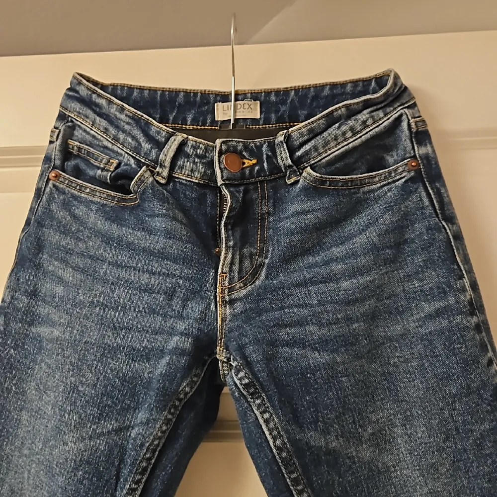 Ett par mörkblå lågmidjade utsvänga jeans ifrån lindex. Storlek 34.. Jeans & Byxor.